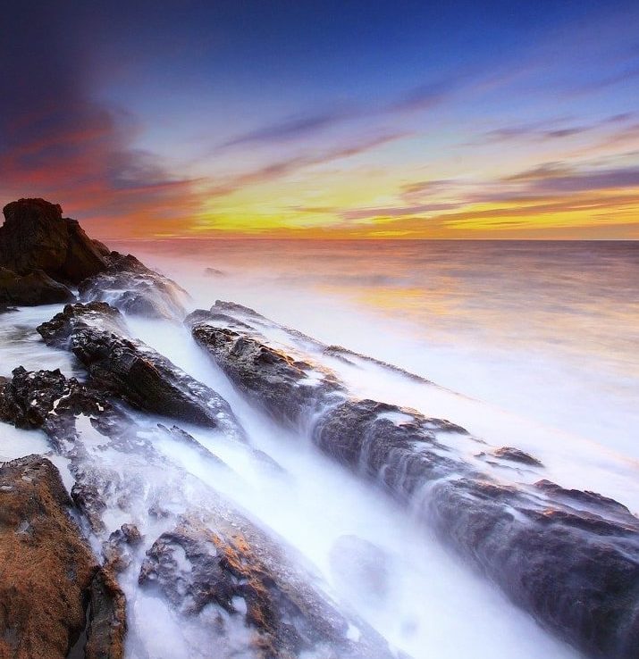 beach waves against rocks